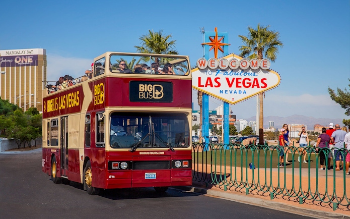 Las Vegas hop-on hop-off bus near Welcome to Fabulous Las Vegas sign.