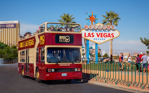 Las Vegas hop-on hop-off bus near Welcome to Fabulous Las Vegas sign.