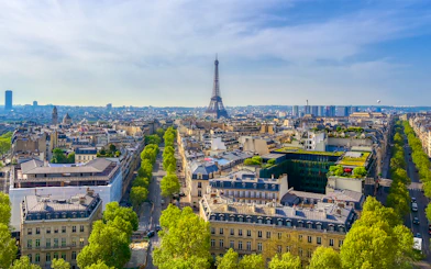 View of the Eiffel Tower from the Arc de Triomphe, Paris skyline in foreground.