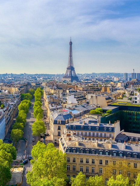 View of the Eiffel Tower from the Arc de Triomphe, Paris skyline in foreground.