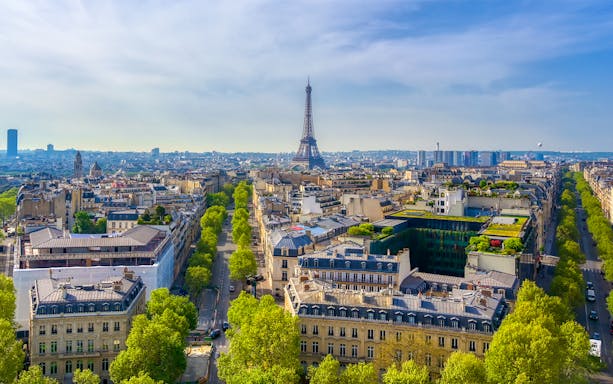 View of the Eiffel Tower from the Arc de Triomphe, Paris skyline in foreground.