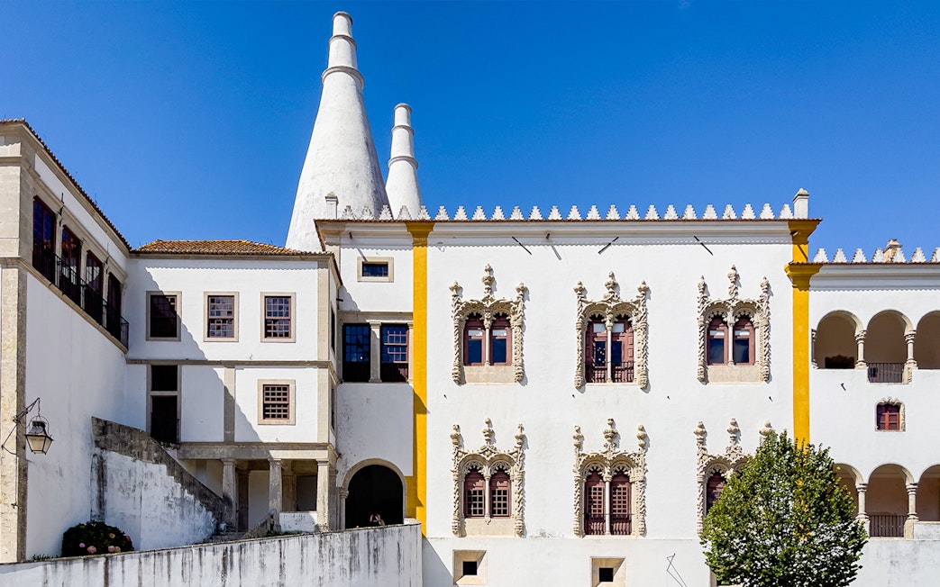National Sintra Palace exterior with iconic chimneys and ornate windows in Sintra, Portugal.
