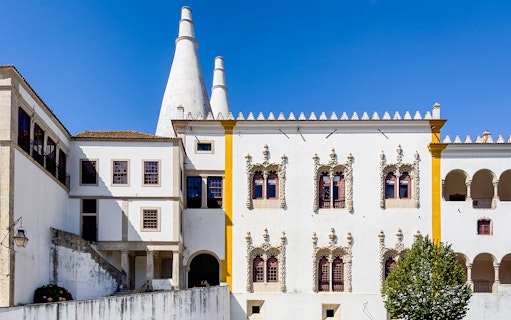 National Sintra Palace exterior with iconic chimneys and ornate windows in Sintra, Portugal.