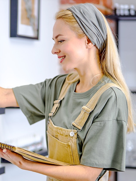 Perfumer selecting fragrance bottle at Fragonard Eze.