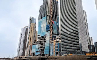 St Regis building under construction in Chicago with surrounding skyscrapers.