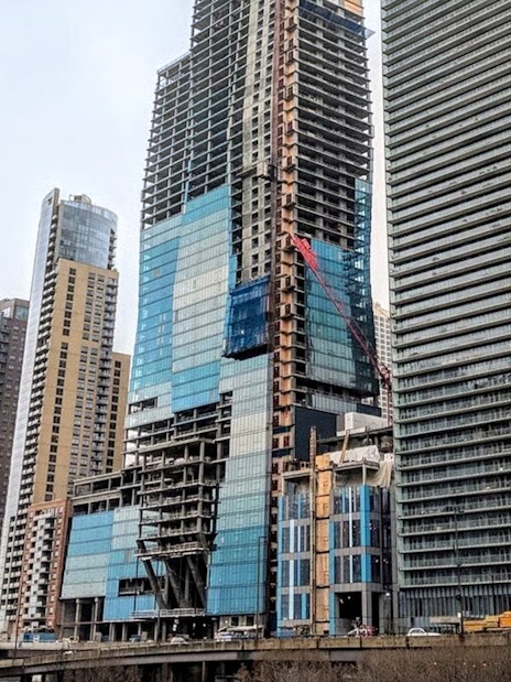 St Regis building under construction in Chicago with surrounding skyscrapers.