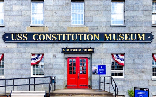 USS Constitution Museum entrance with red doors and patriotic bunting.