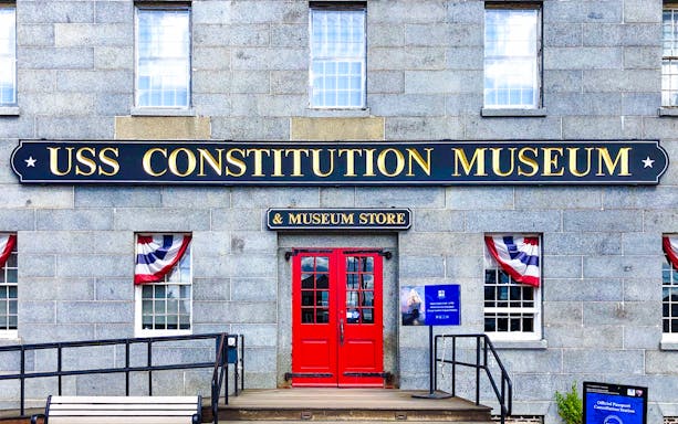 USS Constitution Museum entrance with red doors and patriotic bunting.