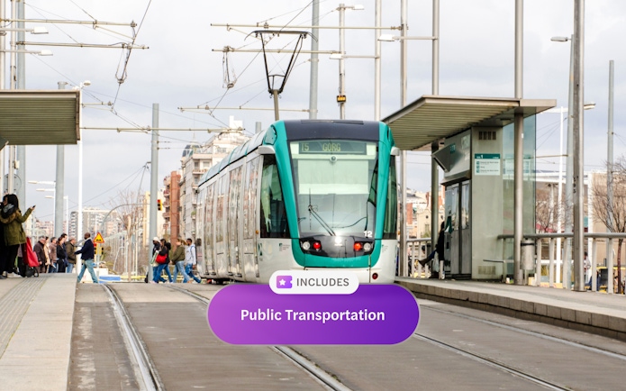 Tram at a station in Barcelona with passengers boarding.
