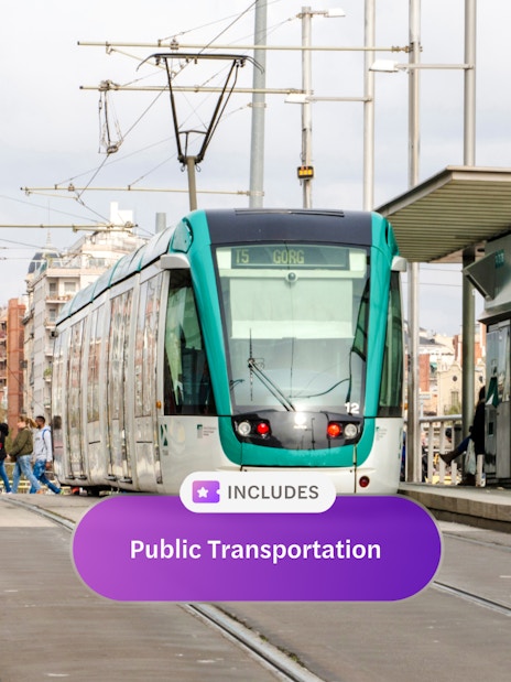 Tram at a station in Barcelona with passengers boarding.