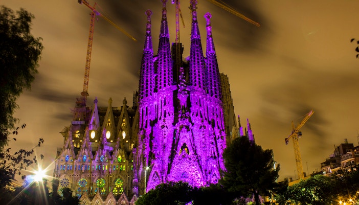 Sagrada Família illuminated in purple at night, long exposure, Barcelona, Spain.