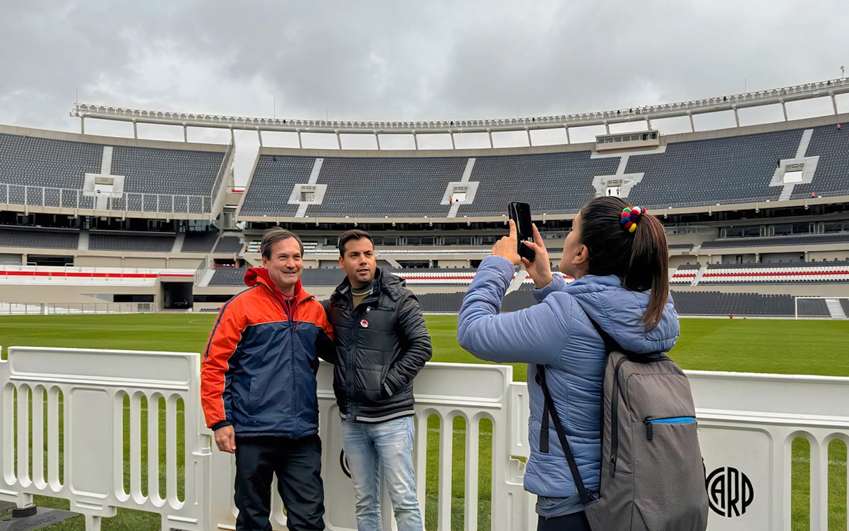 Tourists taking photos at La Bombonera stadium in Buenos Aires.