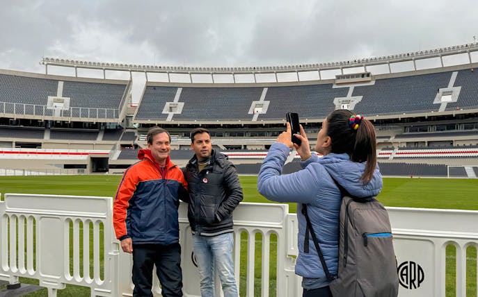 Tourists taking photos at La Bombonera stadium in Buenos Aires.