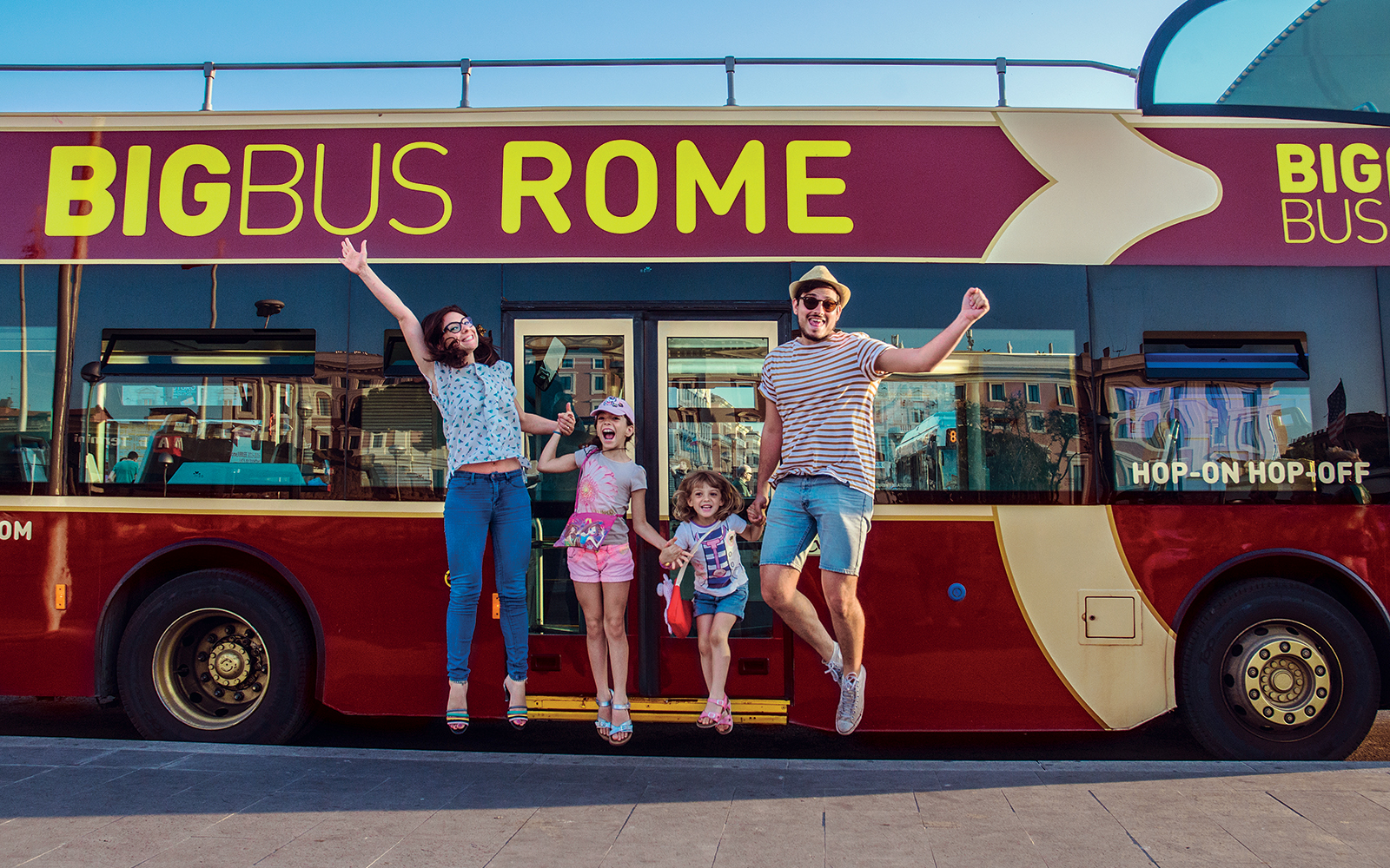 Open-top double-decker bus touring past the Colosseum in Rome, Italy, part of Big Bus Tours Rome.