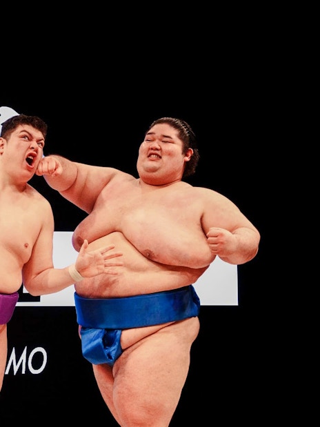 Sumo wrestlers in a match during a training experience in Osaka.