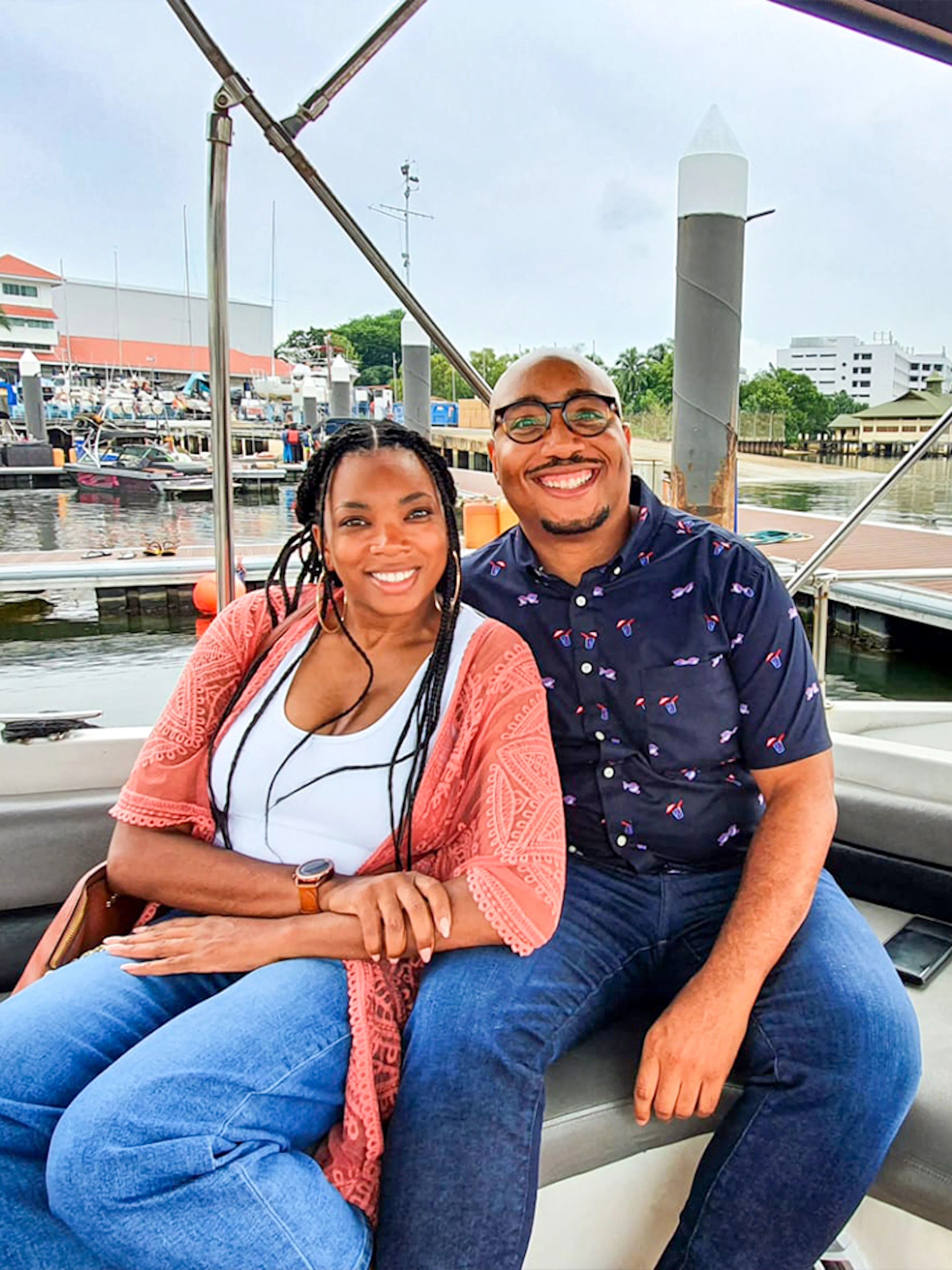 Couple enjoying a boat tour at a marina in Let's Go Kelong.
