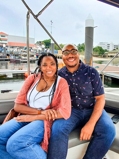 Couple enjoying a boat tour at a marina in Let's Go Kelong.