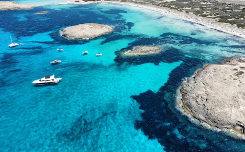 Aerial view of Ibiza island with boats during Formentera Cruise Tour.