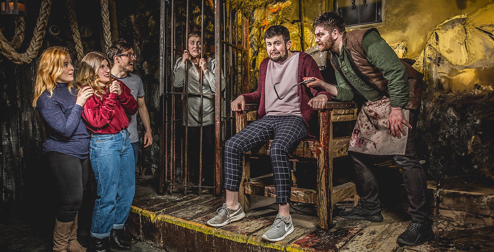 Visitors experiencing a theatrical horror scene at Edinburgh Dungeon.
