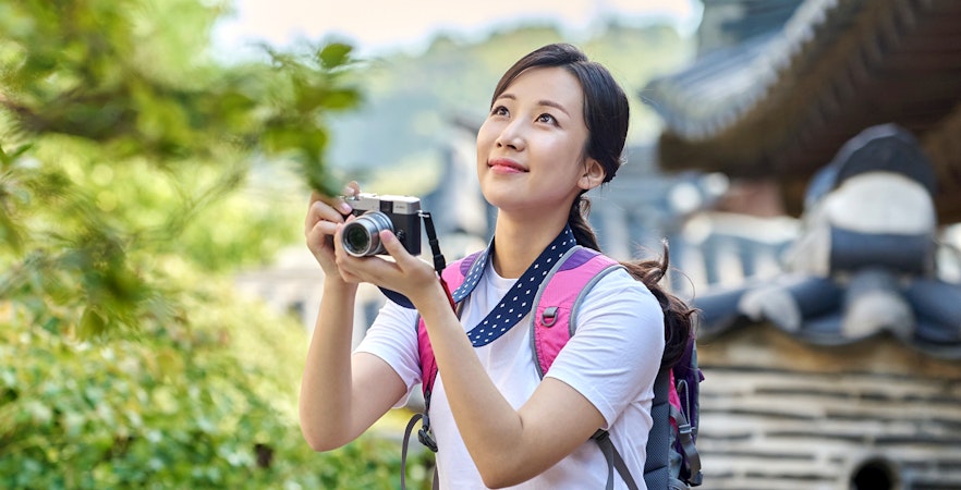 Asian woman traveling and taking photos in Seoul