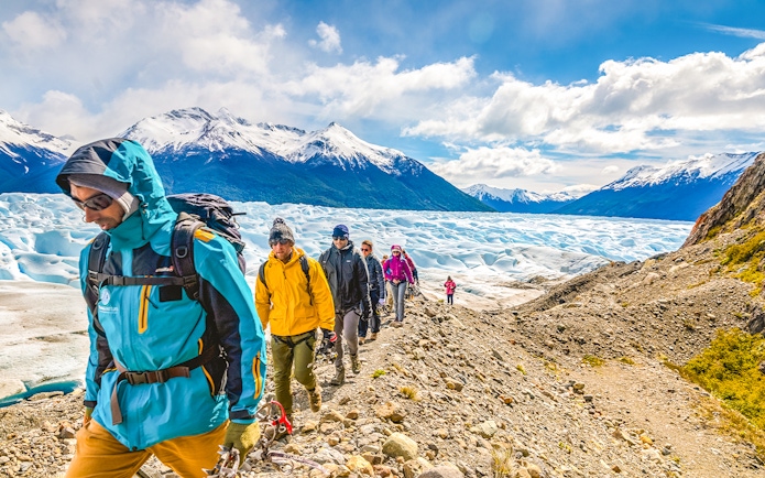 Tourists hiking with a guide on Perito Moreno Glacier, Argentina.