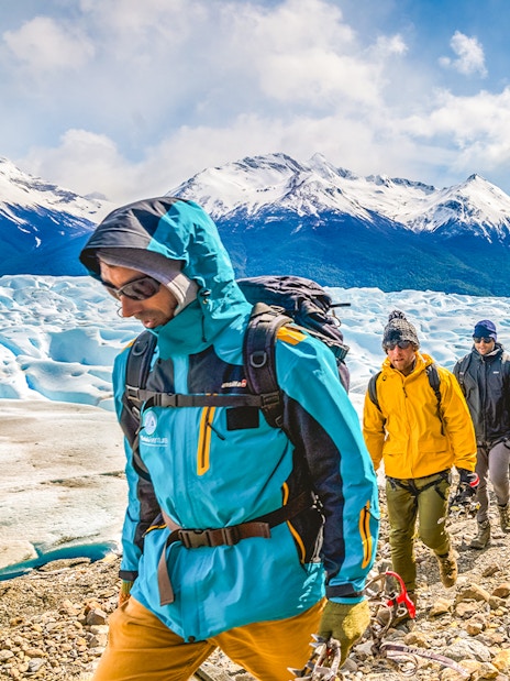 Tourists hiking with a guide on Perito Moreno Glacier, Argentina.