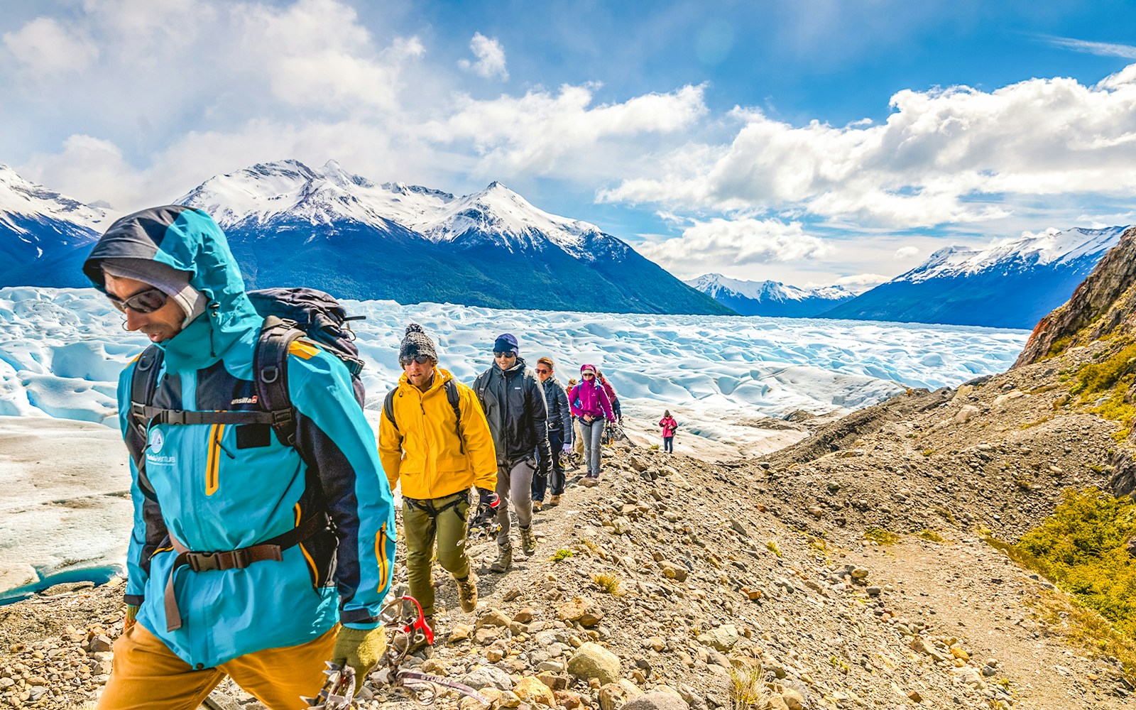 Tourists hiking with a guide on Perito Moreno Glacier, Argentina.