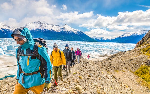Tourists hiking with a guide on Perito Moreno Glacier, Argentina.