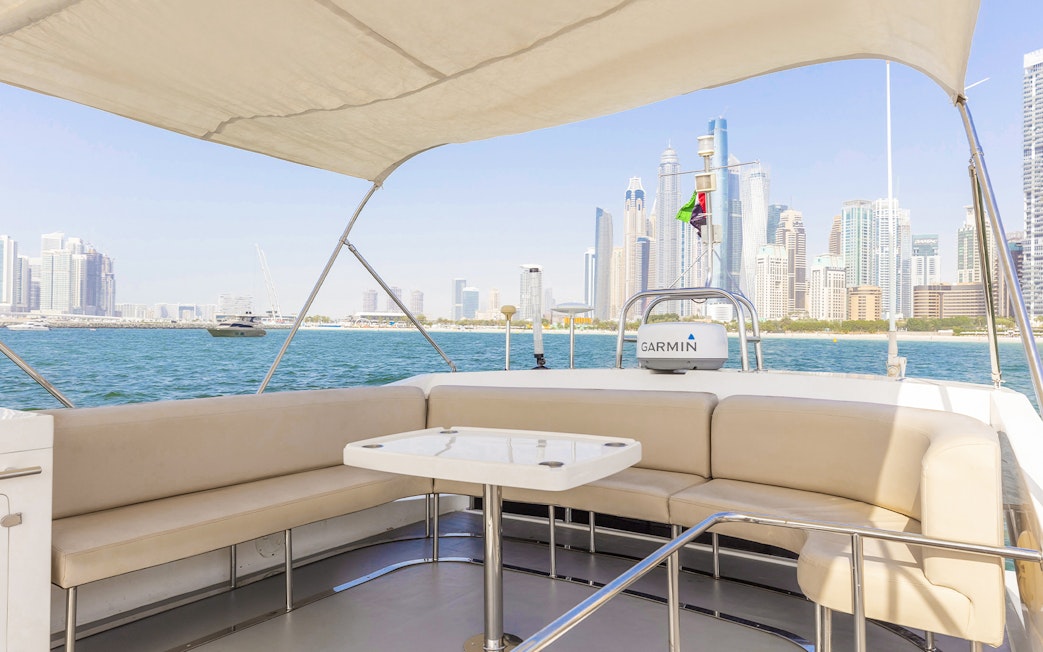 Private yacht deck with Dubai skyline in the background, 46 ft rental.