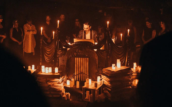 Masquerade Broadway stage performance with actor in mask surrounded by candles.