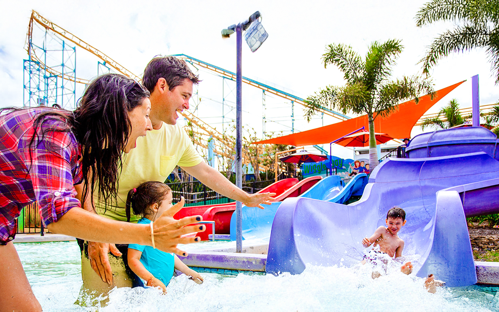 Family enjoying water slide at Wiggle Bay, Whitewater World, Gold Coast.