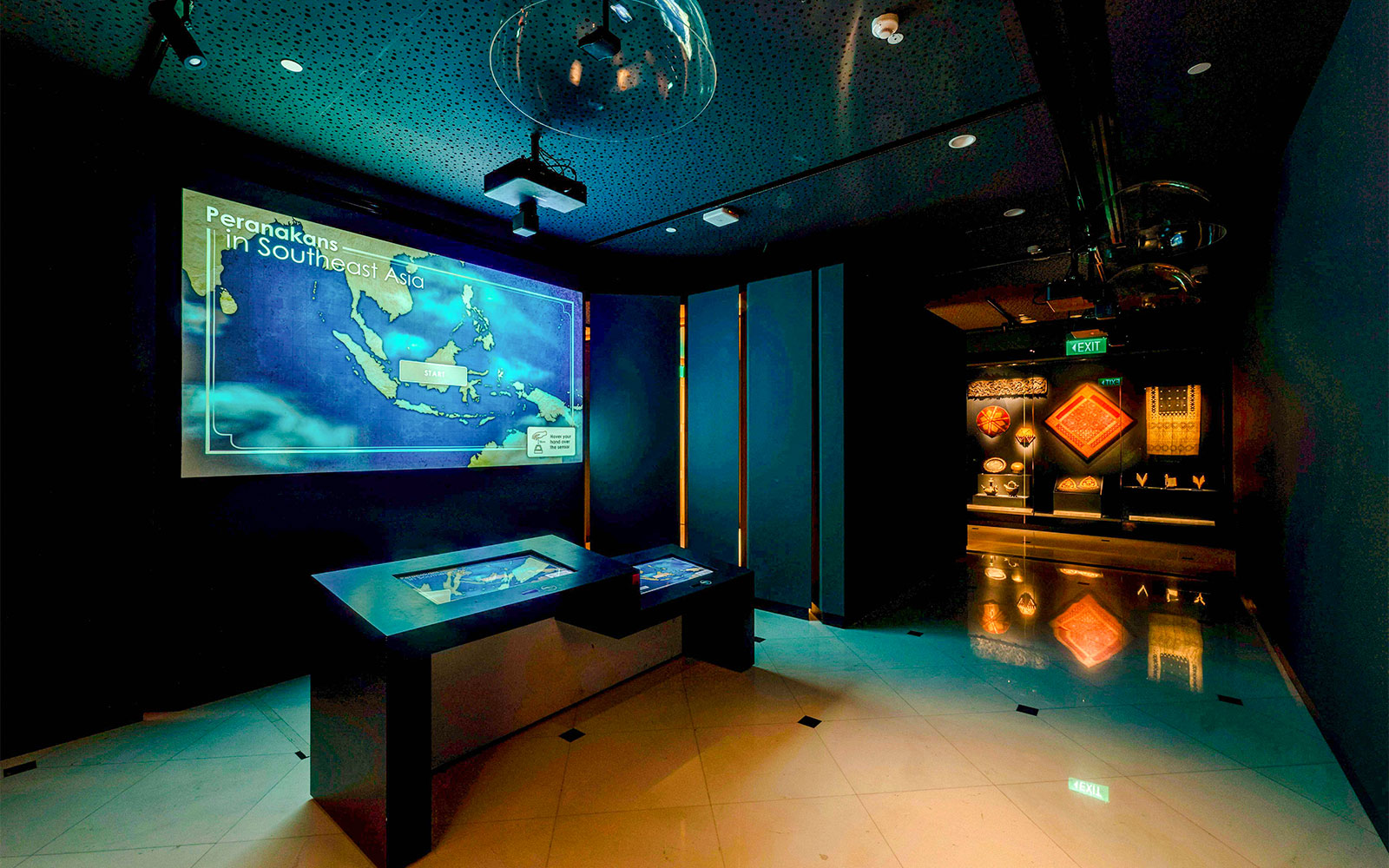 Peranakan Museum gallery with Southeast Asia map display and cultural artifacts.