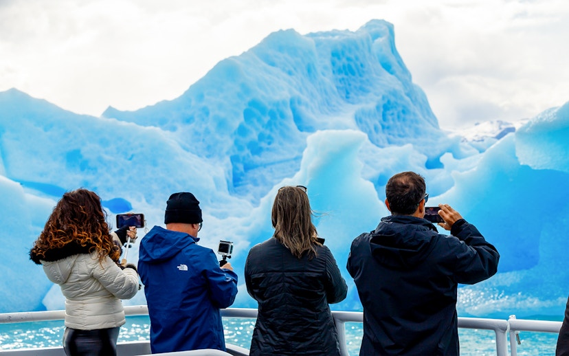 Tourists photographing glaciers from a boat near Perito Moreno, Spegazzini, and Upsala.