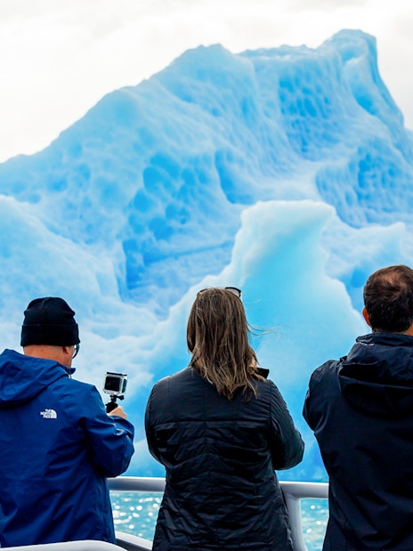 Tourists photographing glaciers from a boat near Perito Moreno, Spegazzini, and Upsala.