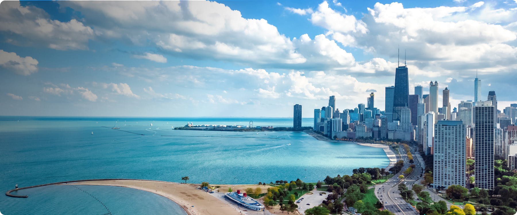 Chicago skyline with Lake Michigan and Navy Pier in the foreground.