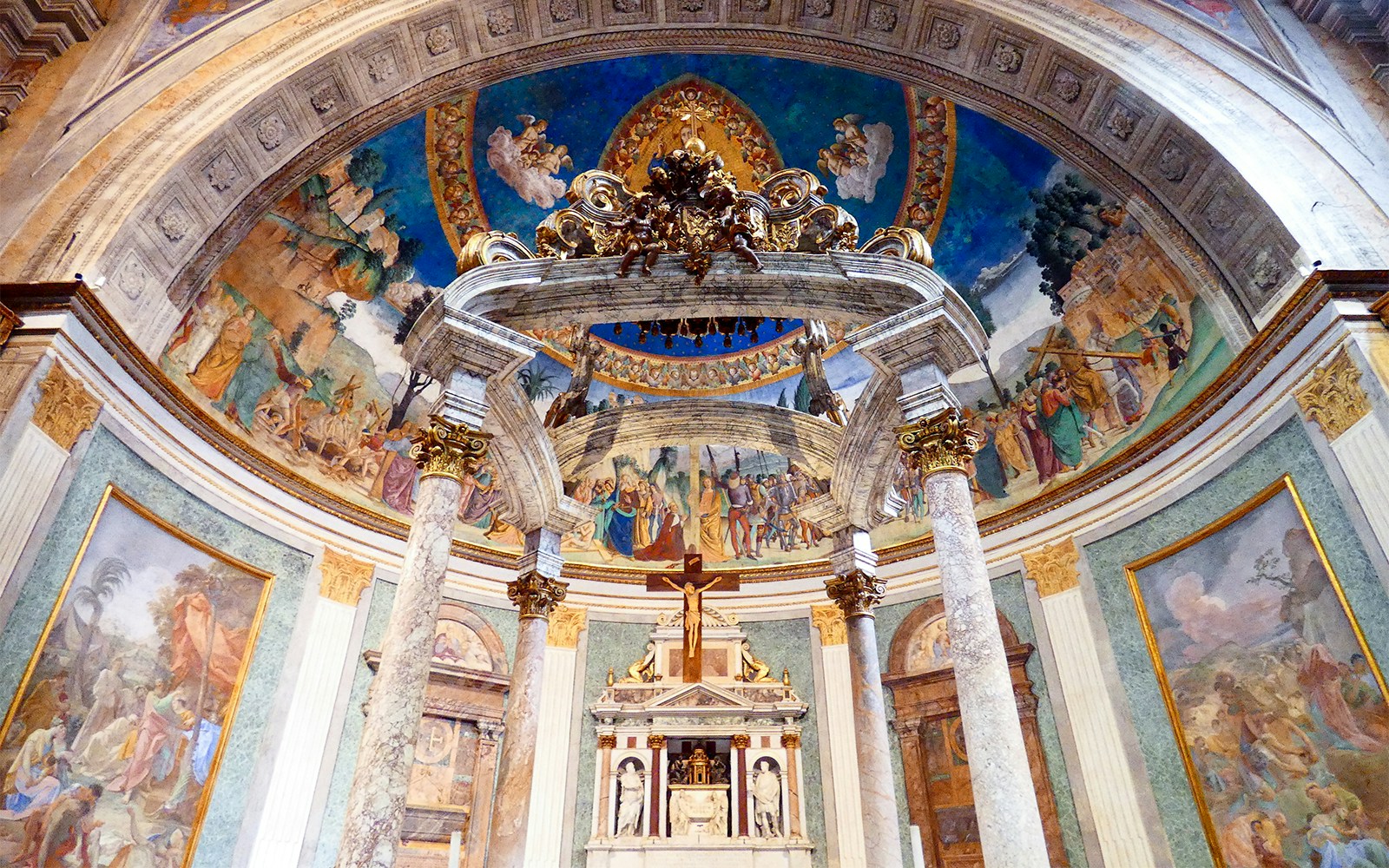 Basilica of Santa Croce interior with ornate frescoes and marble columns in Florence, Italy.