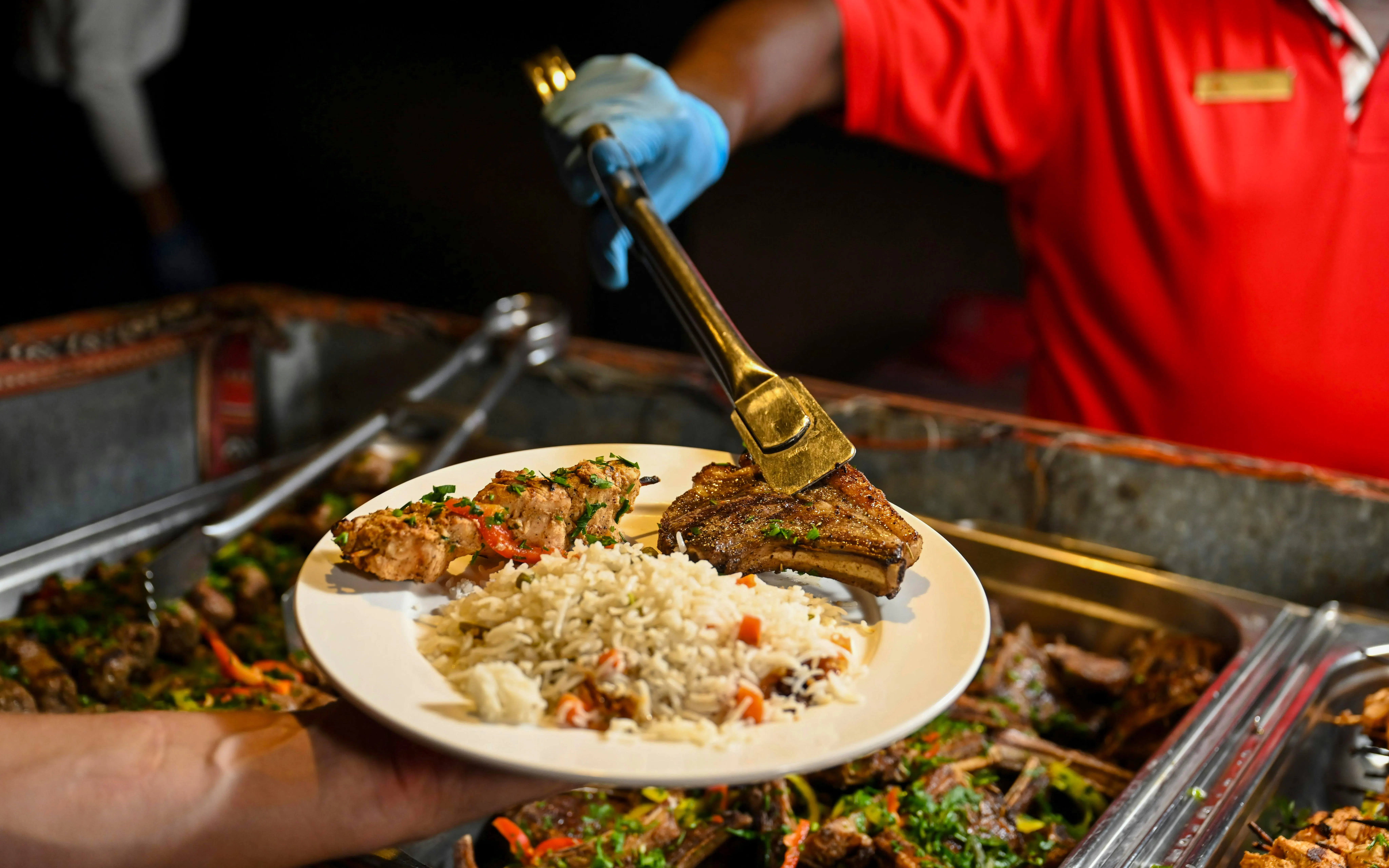 Grilled lamb chops and rice served during desert safari meal.