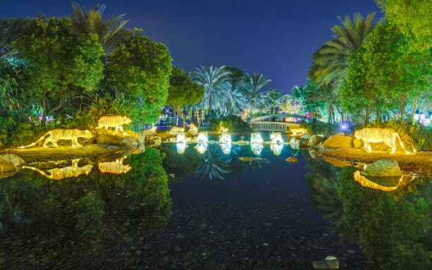 Illuminated animal sculptures and palm trees at Dubai Garden Glow.