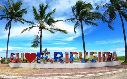 Paripueira Beach sign with palm trees, Maceió, Brazil.