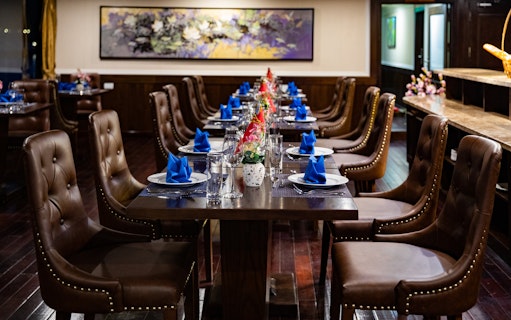 Dining area on a Lan Ha Bay cruise ship with set tables and elegant decor.