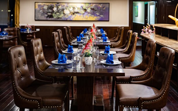 Dining area on a Lan Ha Bay cruise ship with set tables and elegant decor.