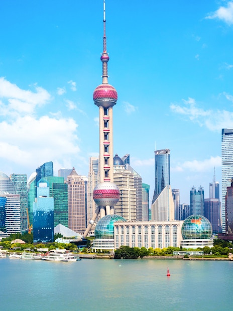 Cruise on Huangpu River with view of Oriental Pearl Tower and Shanghai skyline.