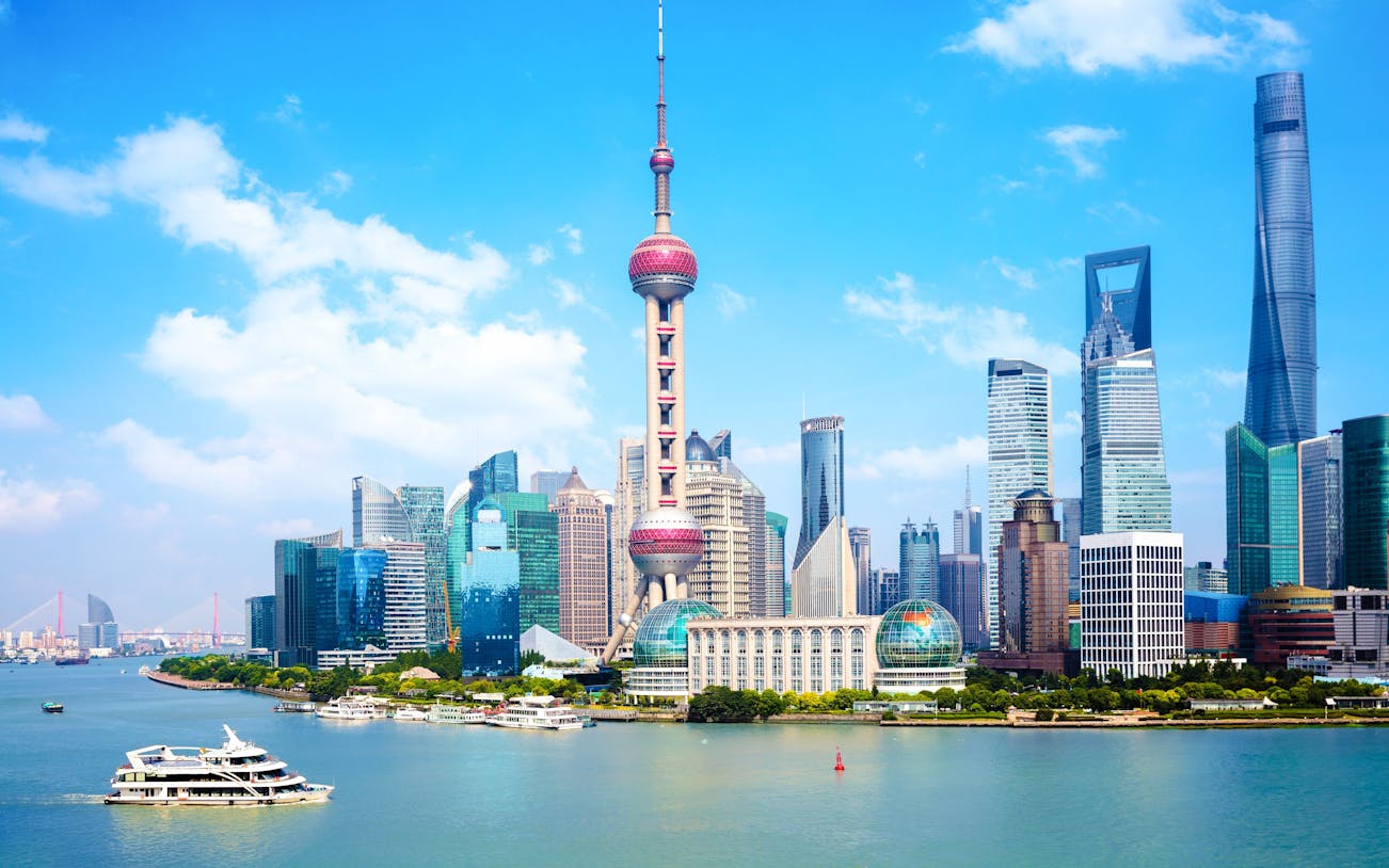 Cruise on Huangpu River with view of Oriental Pearl Tower and Shanghai skyline.