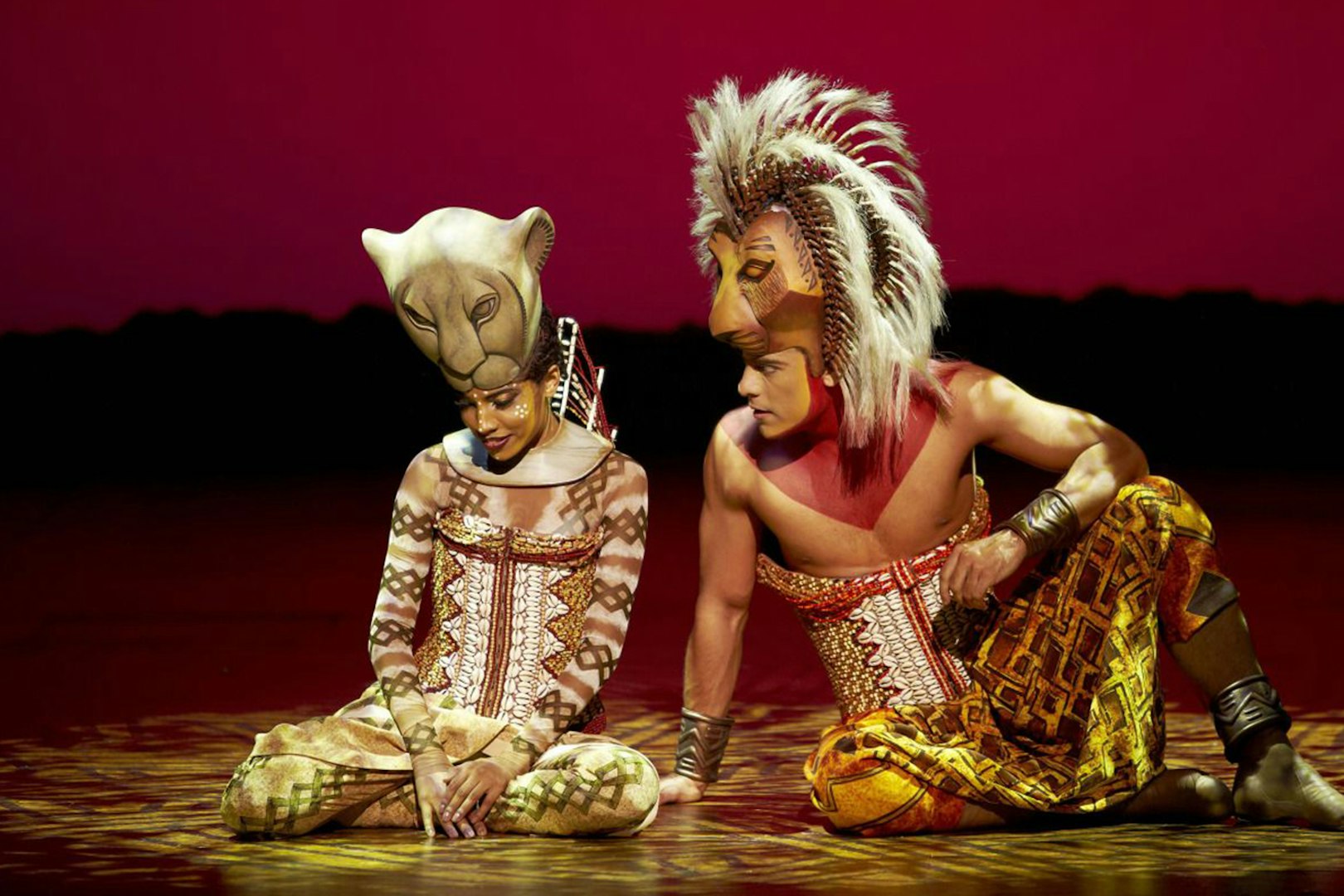Performers in lion costumes on stage at The Lion King, Teatro Lope de Vega.