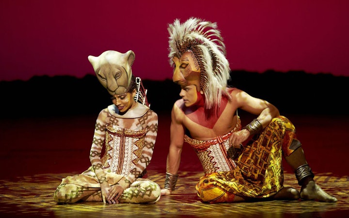 Performers in lion costumes on stage at The Lion King, Teatro Lope de Vega.