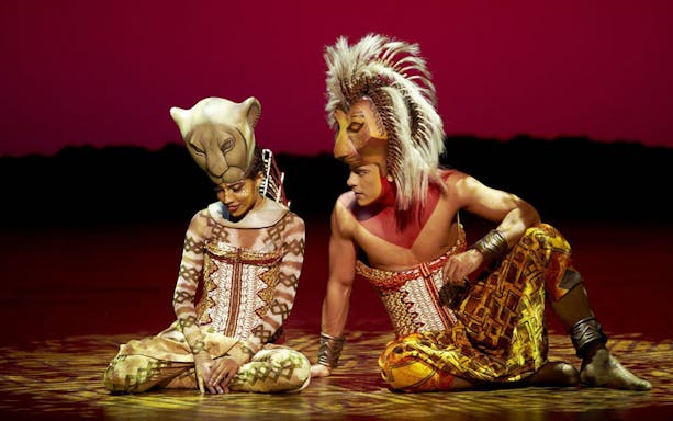 Performers in lion costumes on stage at The Lion King, Teatro Lope de Vega.