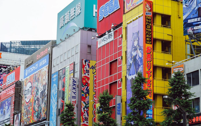 Colorful anime and gaming billboards in Akihabara, Tokyo, showcasing vibrant street culture.