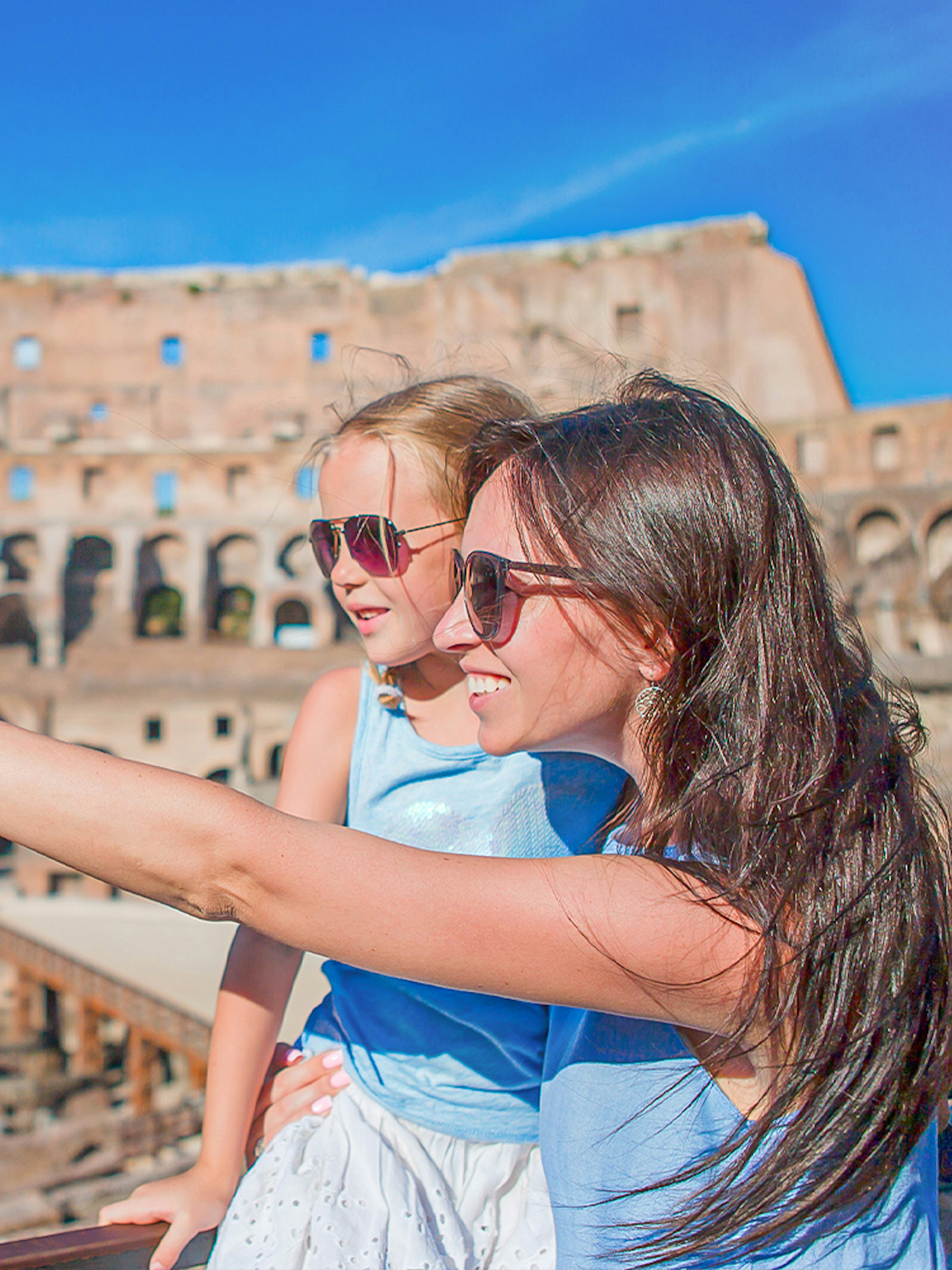 Parent explaining the Colosseum to child in Rome, Italy.