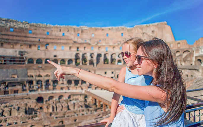 Parent explaining the Colosseum to child in Rome, Italy.