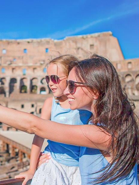 Parent explaining the Colosseum to child in Rome, Italy.
